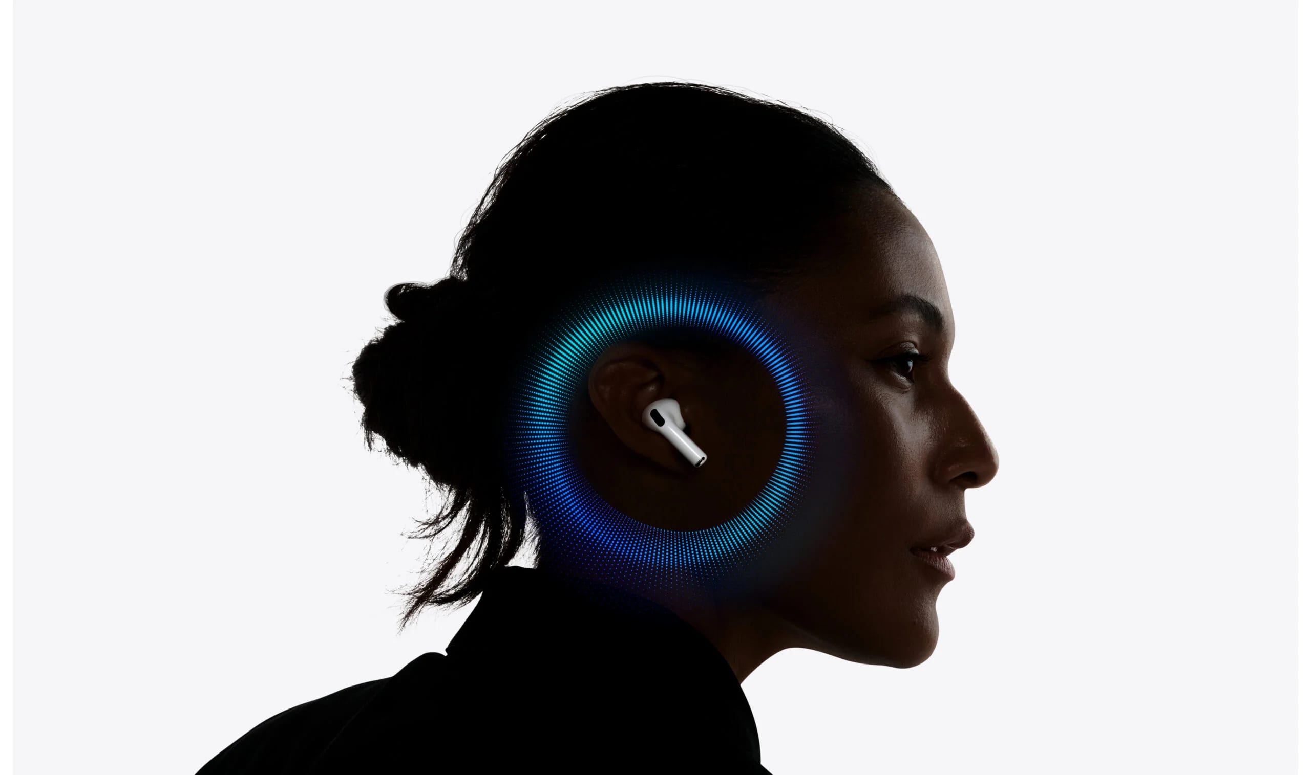 A woman in profile wearing an Apple AirPods Pro earbud